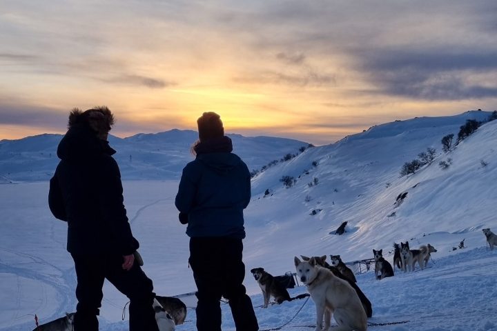a group of people standing on top of a snow covered slope