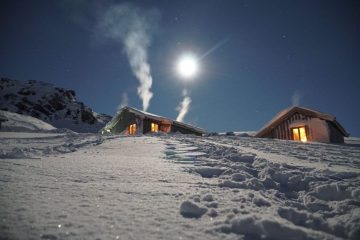 a cabin on a snow covered slope