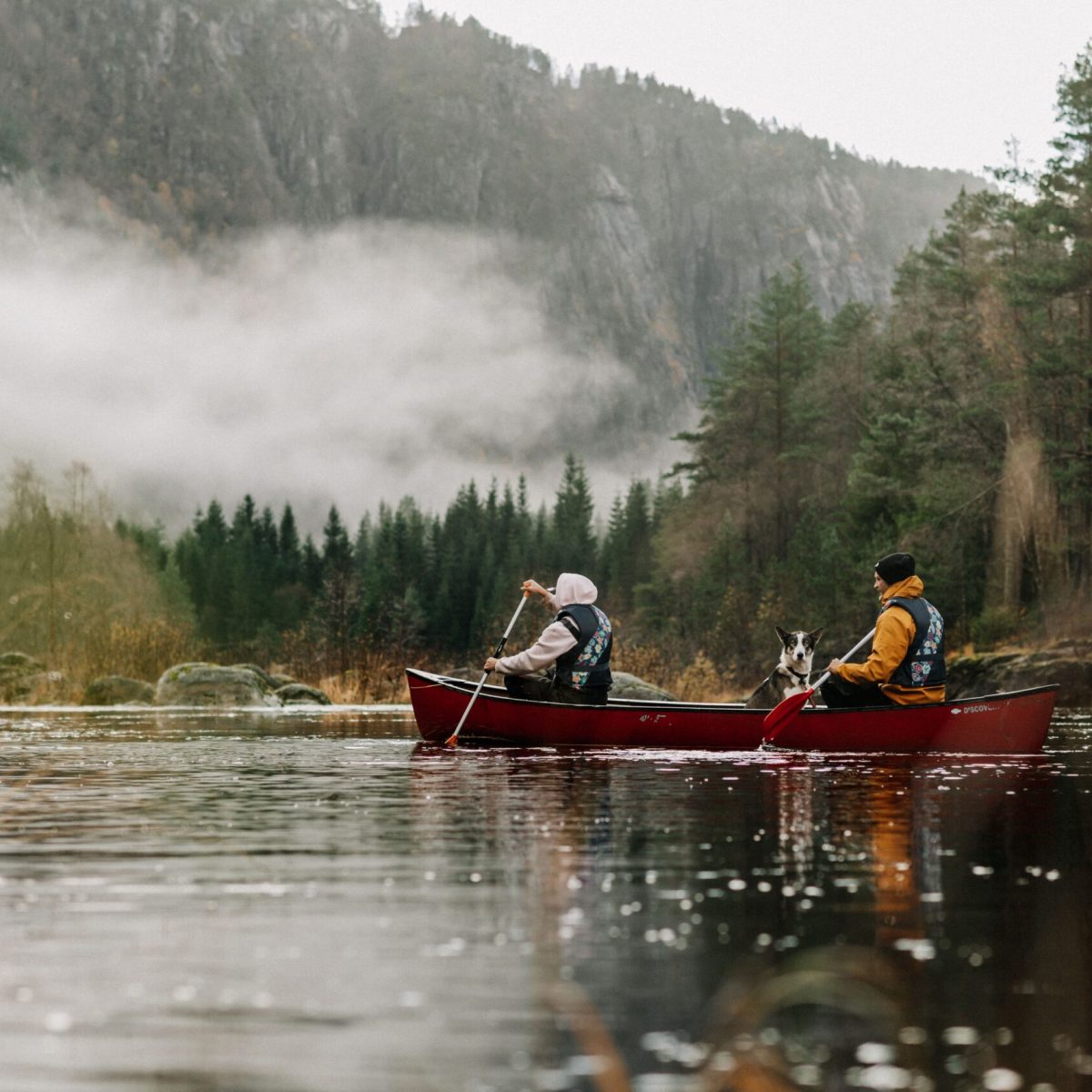 two people riding a canoe on the river