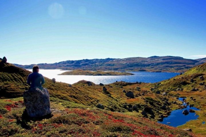 a man standing on a rocky hill
