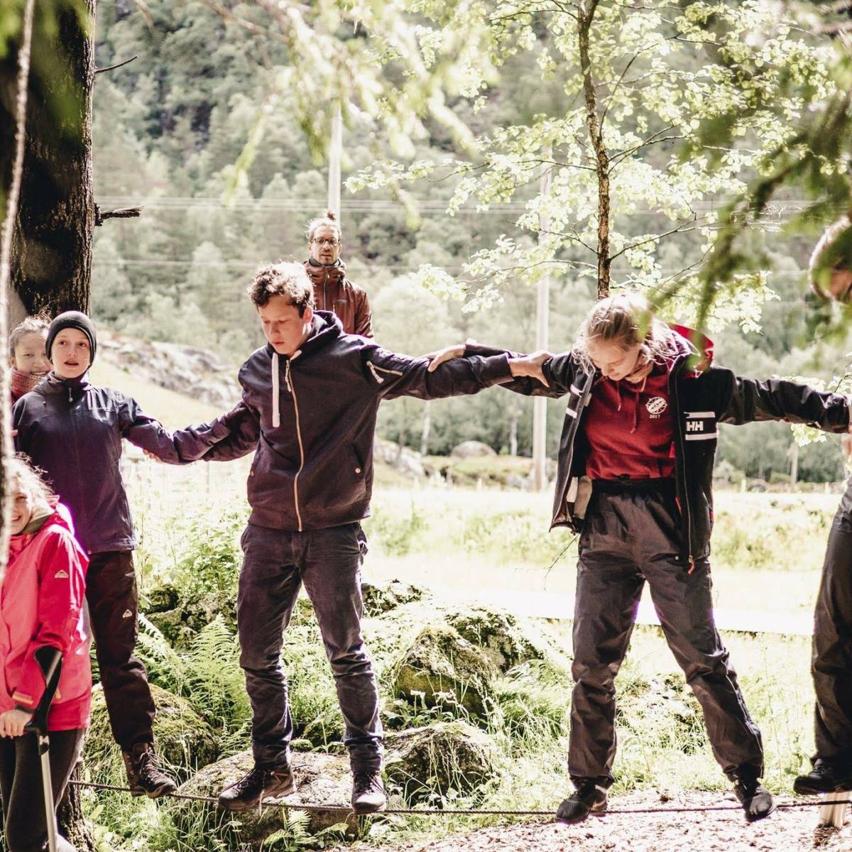 a group of people standing next to a tree