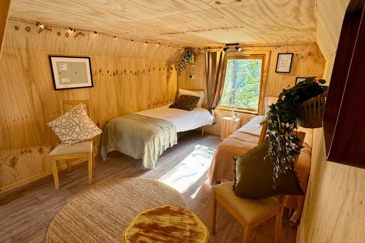 a bedroom with a bed and a chair