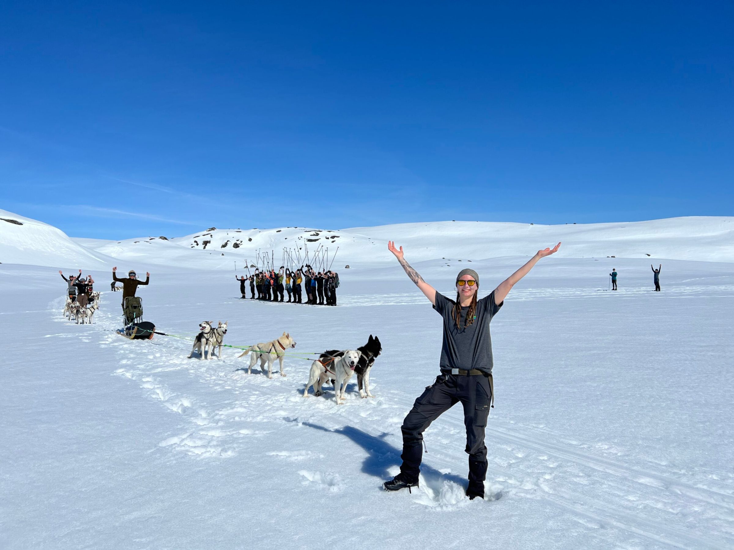 a group of people riding skis down a snow covered slope
